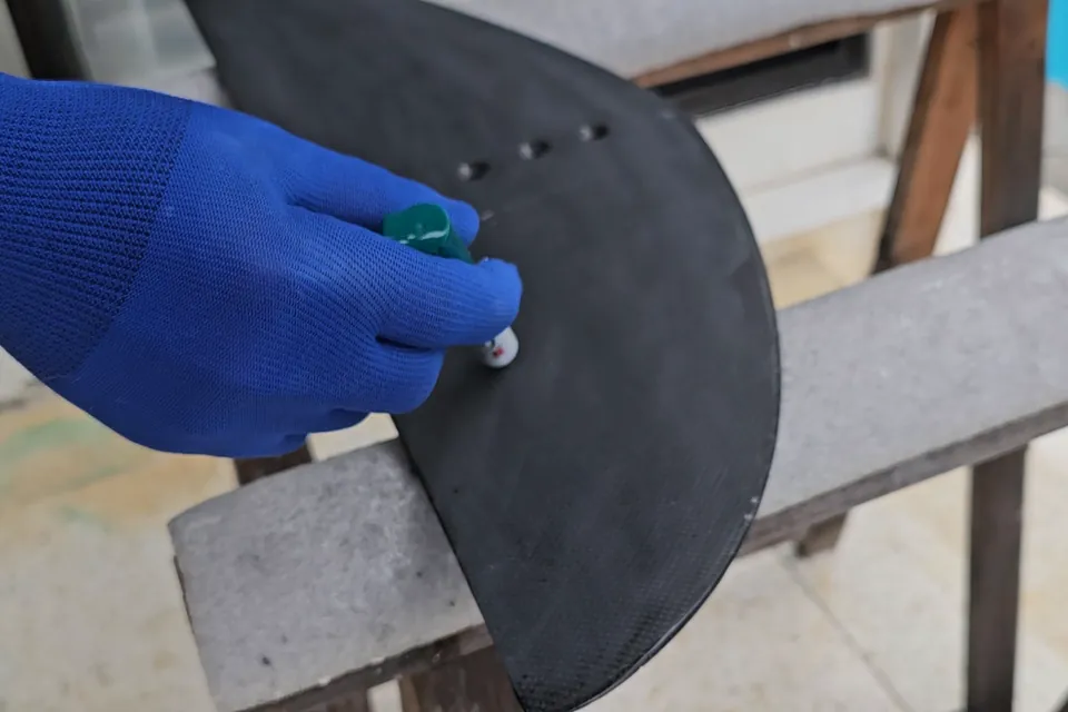 Gloved hand drawing the centerline back onto a repaired stabilizer