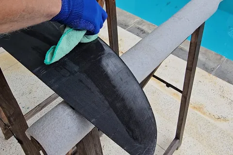 Wiping the sanded wing with a solvent cloth