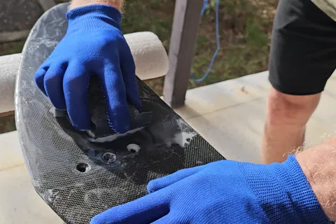 Wet sanding the cured resin with a sanding block