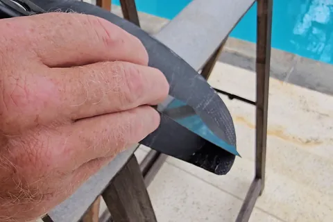 Steel scraper working on the chipped wing tip